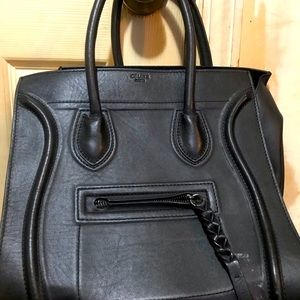 A woman’s Black Celine handbag.